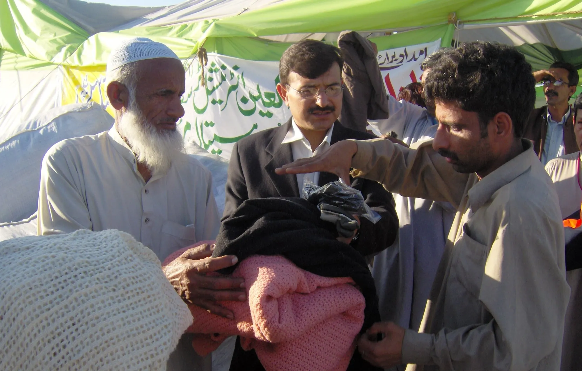 Al-Ain volunteers handing out warm clothes to families