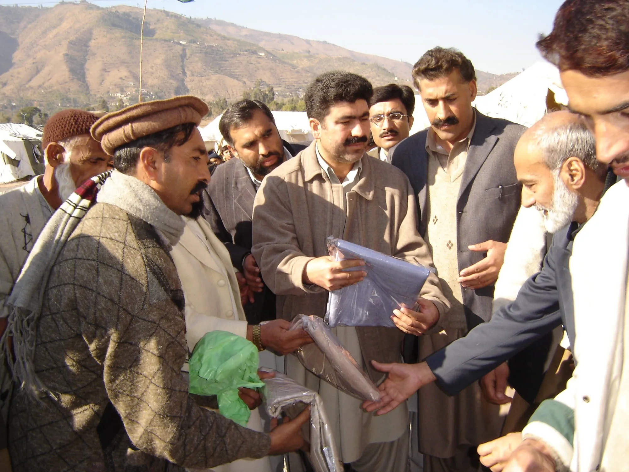 Al-Ain trustees with families at a distribution in Pakistan