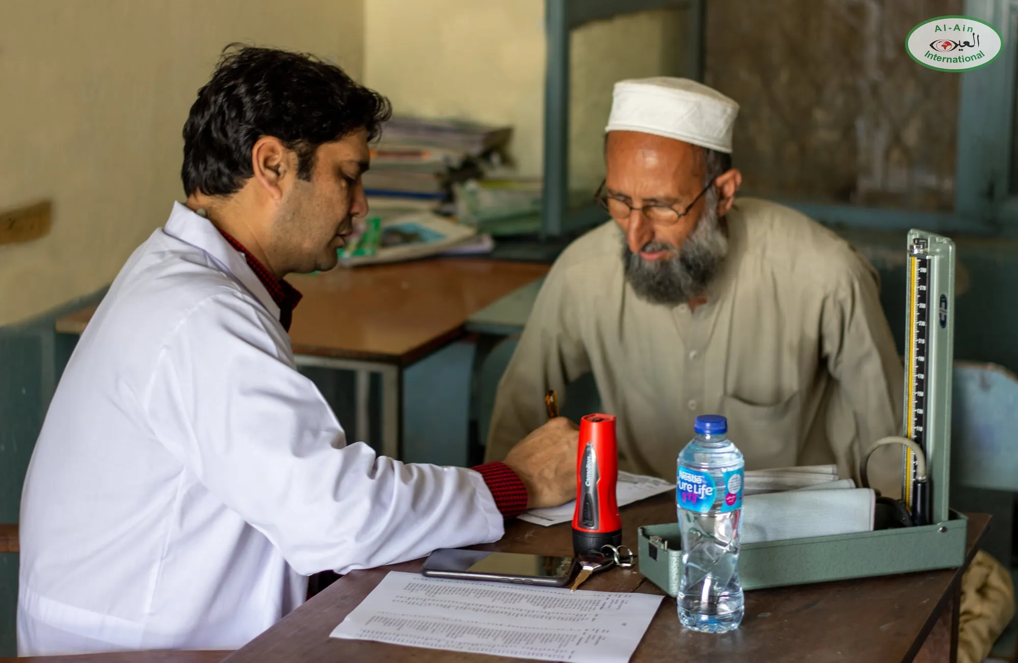 A doctor from Umeed (Hope) Hospital sees an elderly patient at a free medical camp in Swabi