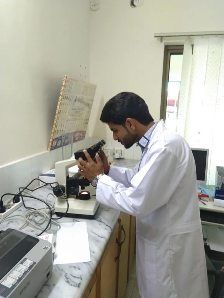 A laboratory technician uses a microscope