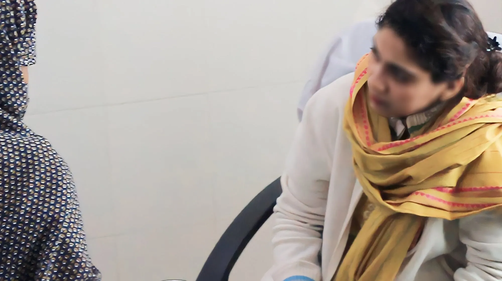 A female doctor speaks with a patient during the camp at Umeed (Hope) Hospital
