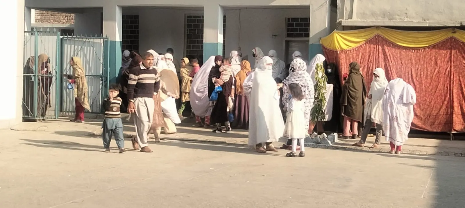 Patients and families gathered outside the camp building in Tando Koi