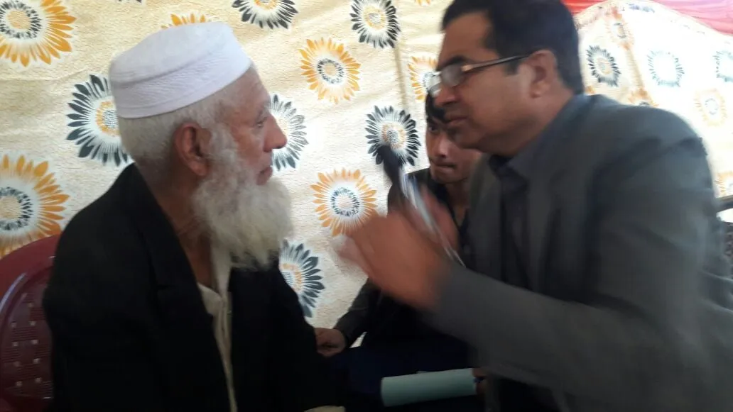 A doctor examines an elderly patient at the Thand Koi eye camp