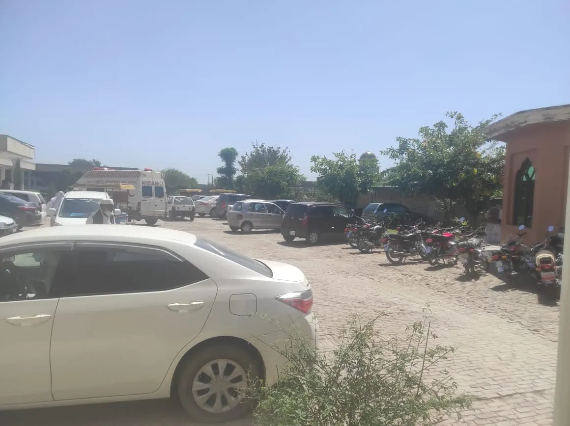 Cars parked outside Umeed (Hope) Hospital as people arrive for vaccination